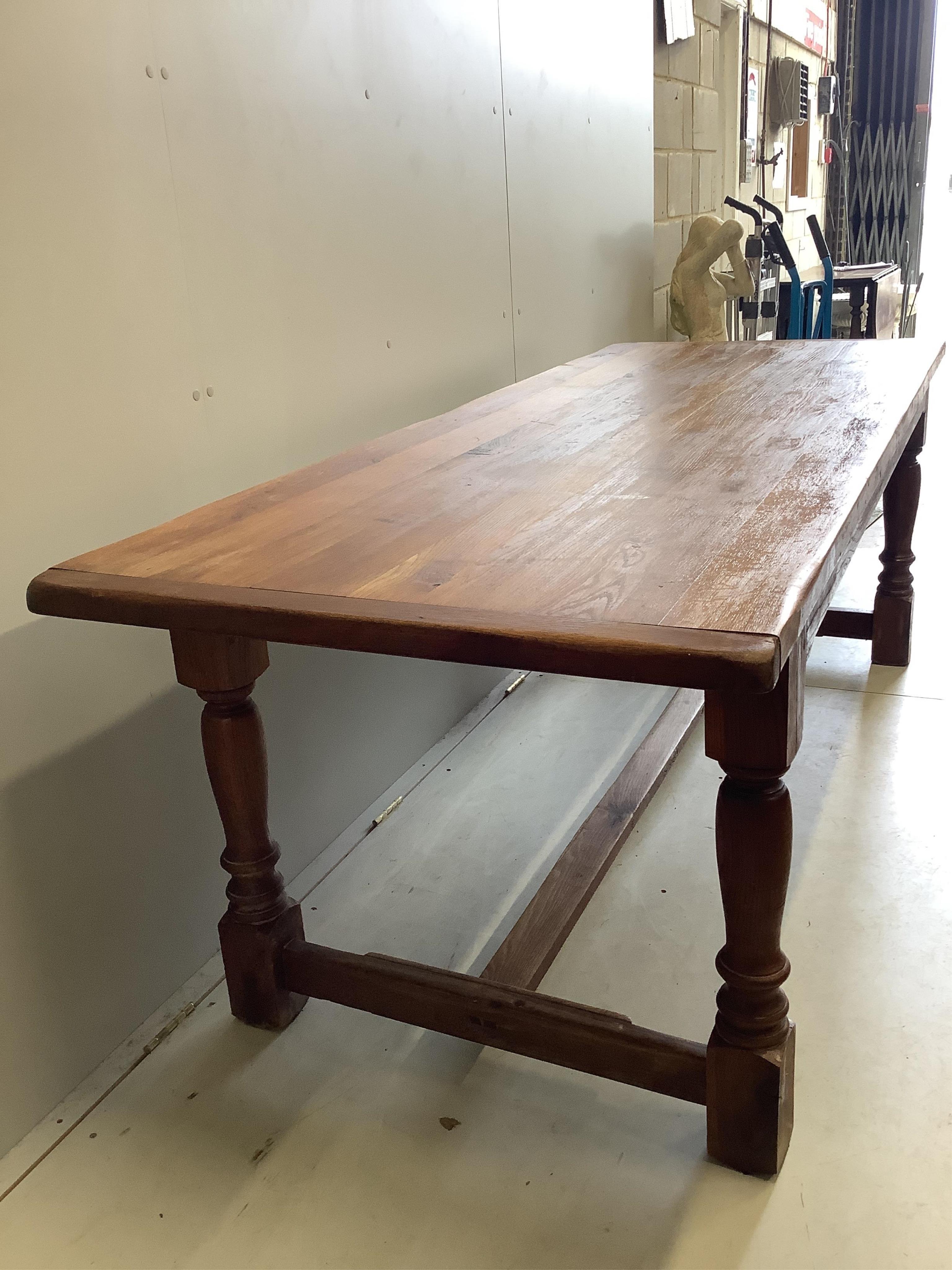 A rectangular oak refectory dining table, width 220cm, depth 84cm, height 74cm. Condition - fair